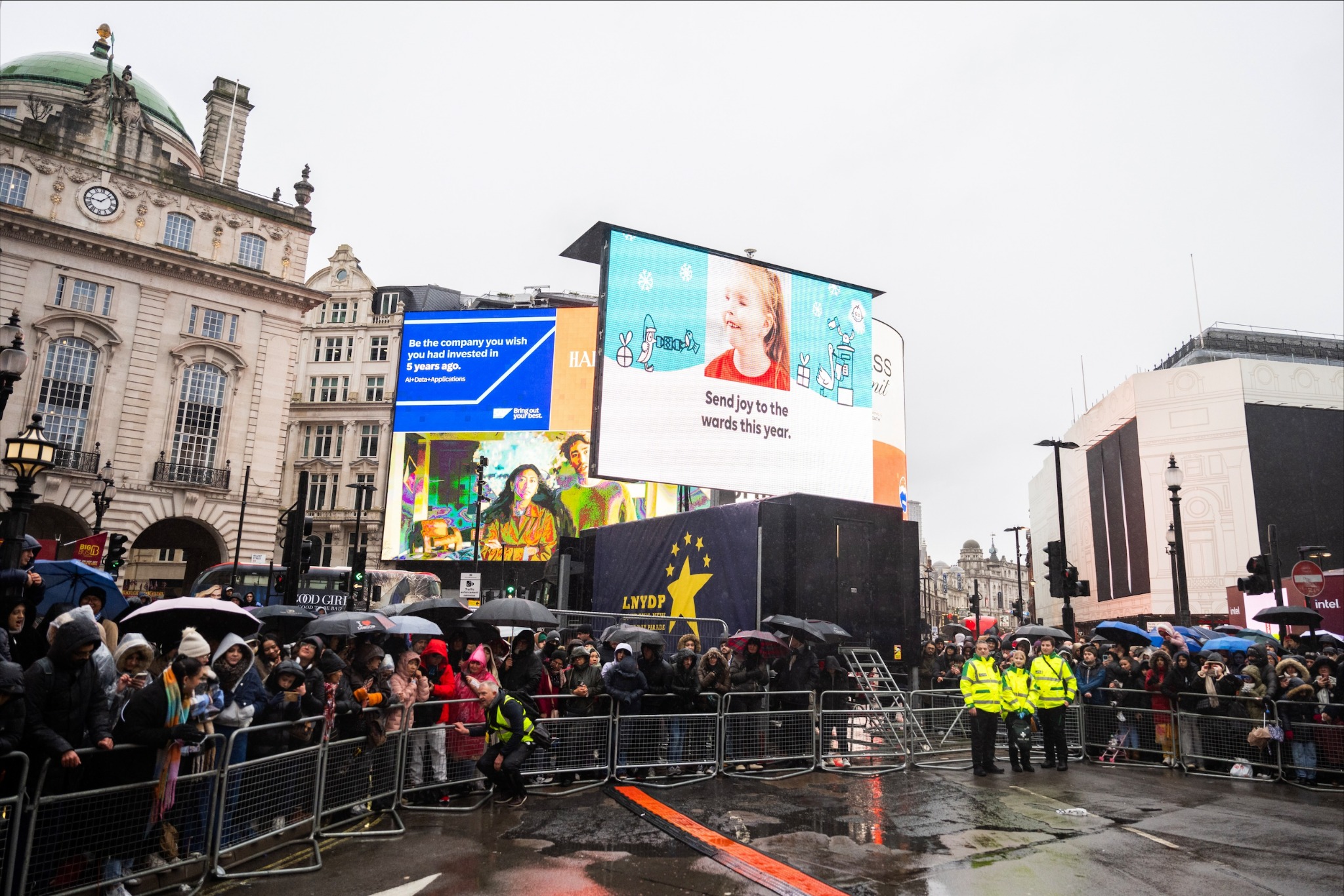 Crowds gather in Piccadilly Circus during a festive London parade.